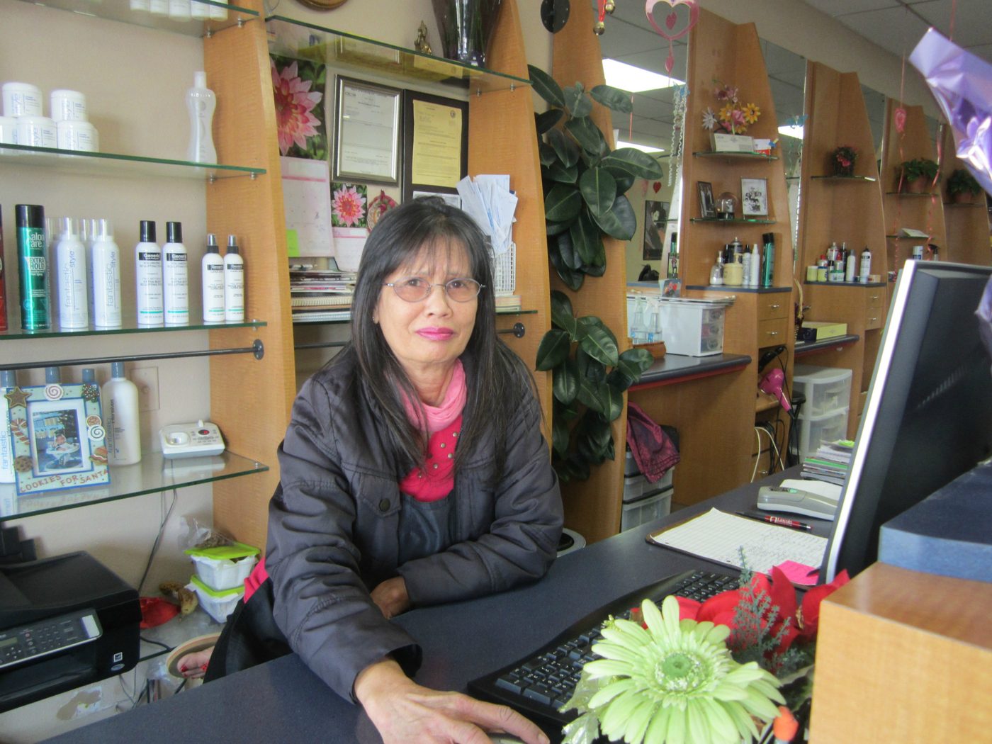 Front desk with hair care products on the shelves behind